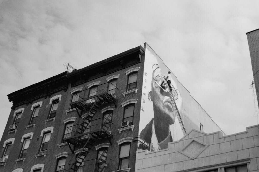 Black and white six-story mural “Rose Coloured Glasses” by Brad Robson, Chinatown Lower East Side NYC