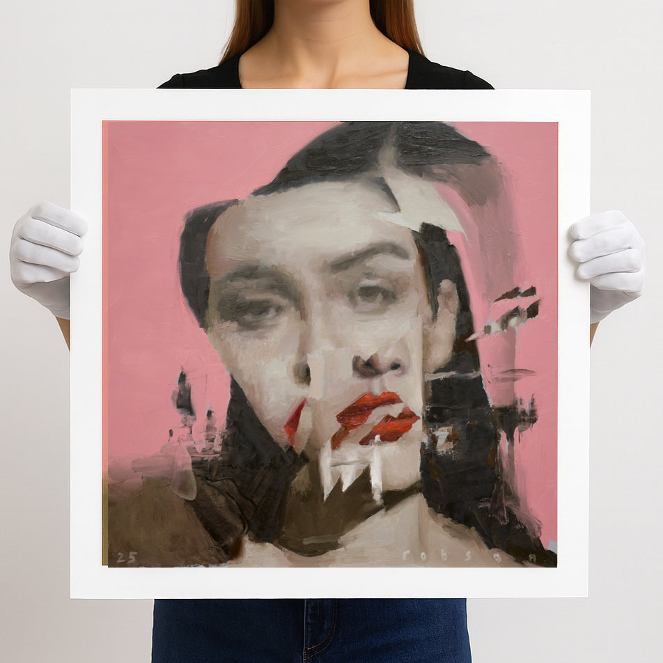 Person holding a framed artwork with a stylized portrait on a pink background