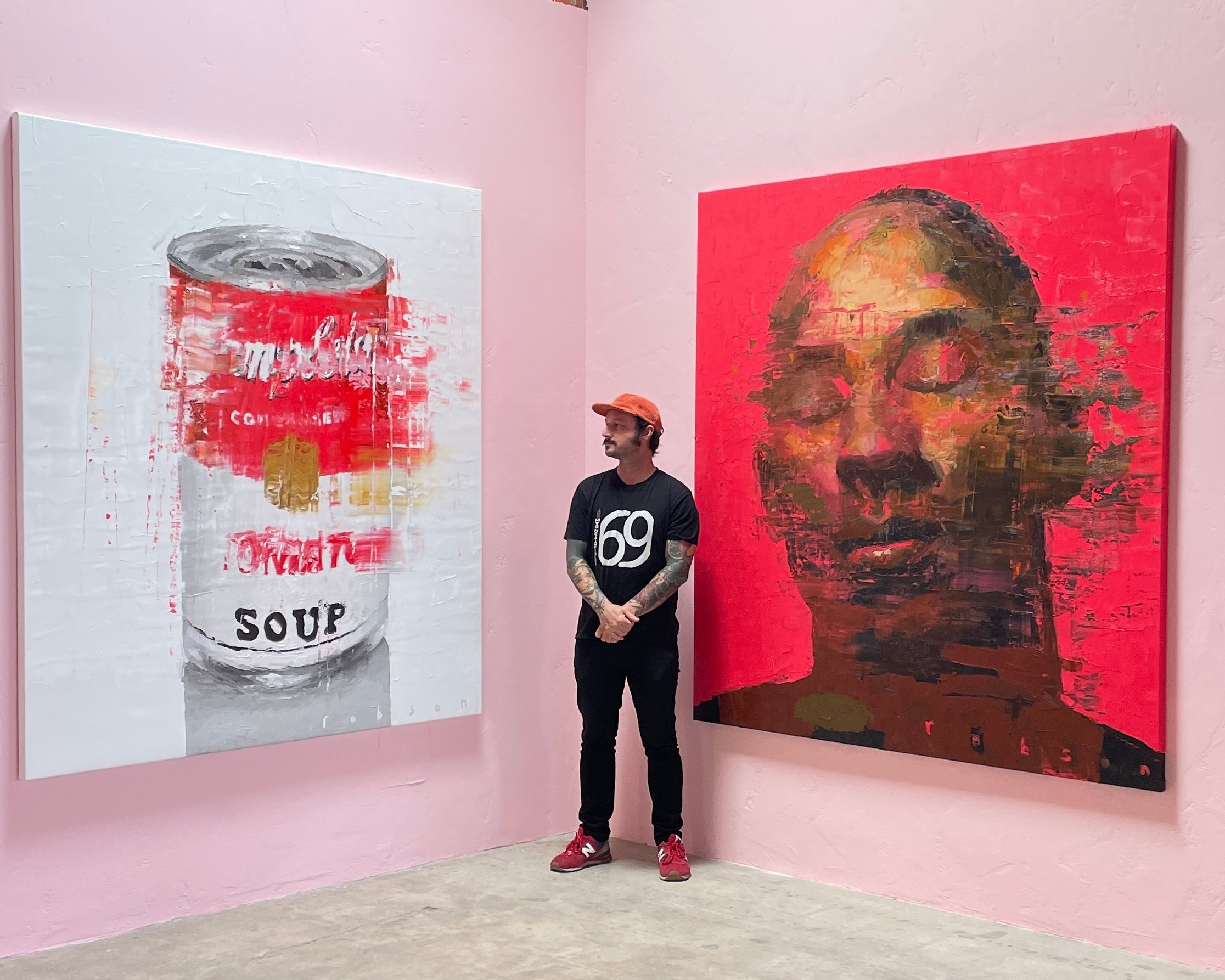 Robson standing next to his kobe portrait in Los Angeles