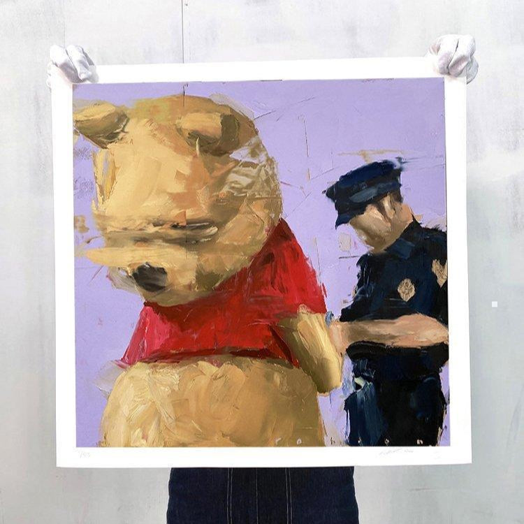 Limited edition print of Brad Robson’s painting “Winnie the Pooh Being Arrested,” held up for display

Alt text (SEO-boosted version):